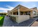 Exterior view of the house featuring an outdoor kitchen, covered patio, and beautiful landscaping at 25875 S 227Th Way, Queen Creek, AZ 85142