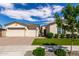 Charming single-Gathering home featuring a three-car garage, a well-manicured lawn, and desert landscaping at 25875 S 227Th Way, Queen Creek, AZ 85142