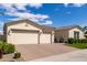 A well-maintained three-car garage situated at the front of a home with tidy desert landscaping and a brick driveway at 25875 S 227Th Way, Queen Creek, AZ 85142