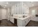 Large kitchen featuring white cabinets, modern appliances, plenty of storage, and sleek countertops at 25875 S 227Th Way, Queen Creek, AZ 85142