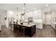 Open kitchen with island seating, stainless steel appliances, and ample white cabinetry at 25875 S 227Th Way, Queen Creek, AZ 85142