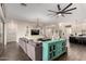 Open-concept living room with a large sectional, hardwood floors, and built-in shelving for entertainment at 25875 S 227Th Way, Queen Creek, AZ 85142