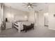 Spacious main bedroom with a decorative bed frame, ceiling fan, and carpeted floors at 25875 S 227Th Way, Queen Creek, AZ 85142