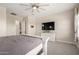 Large main bedroom with a ceiling fan, mounted TV, and neutral tones at 25875 S 227Th Way, Queen Creek, AZ 85142