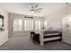 Bright main bedroom features a ceiling fan, large bed, plantation shutters, and neutral tones at 25875 S 227Th Way, Queen Creek, AZ 85142