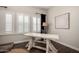 Bright office space features a large desk, modern decor and natural light from three windows at 25875 S 227Th Way, Queen Creek, AZ 85142