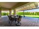 Covered patio with outdoor dining, overhead cover, and well-maintained lawn at 25875 S 227Th Way, Queen Creek, AZ 85142