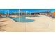 Inviting community pool area featuring ample seating, sun shades, and a splash pad, perfect for summer relaxation at 25875 S 227Th Way, Queen Creek, AZ 85142