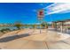 Community splash pad with a water tower, nearby lake, and shaded seating area at 25875 S 227Th Way, Queen Creek, AZ 85142