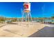 Community splash pad featuring a water tower with a lake and houses in the background at 25875 S 227Th Way, Queen Creek, AZ 85142