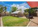 Spacious backyard featuring a covered parking area, mature trees, and plenty of room to relax and enjoy at 2745 S Emerson Cir, Mesa, AZ 85210