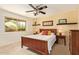 Bright bedroom featuring a large window, ceiling fan, and bedside tables at 2745 S Emerson Cir, Mesa, AZ 85210