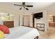 Comfortable bedroom with ceiling fan, television and adjacent bathroom access at 2745 S Emerson Cir, Mesa, AZ 85210