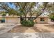 Charming single-story home featuring a covered front porch and mature trees in a well-maintained landscape at 2745 S Emerson Cir, Mesa, AZ 85210