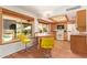 Bright kitchen with tile floors, breakfast bar, and a view of the outdoor area by the pool at 2745 S Emerson Cir, Mesa, AZ 85210