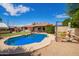 Backyard with a beautiful pool surrounded by mature trees and a seating area at 2745 S Emerson Cir, Mesa, AZ 85210