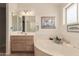 Bright bathroom boasts a soaking tub, decorative accents, and large vanity space at 2926 N 149Th Dr, Goodyear, AZ 85395