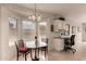 Bright breakfast nook with a charming table, a built-in desk area, and large windows offering plenty of natural light at 2926 N 149Th Dr, Goodyear, AZ 85395