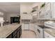 Open kitchen featuring granite countertops, white cabinetry, stainless steel appliances, and a view into the living area at 2926 N 149Th Dr, Goodyear, AZ 85395