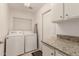 Functional laundry room boasts modern appliances and ample counter space at 2926 N 149Th Dr, Goodyear, AZ 85395