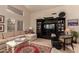 Bright living room featuring tile floors, comfortable seating, a large entertainment center, and a vaulted ceiling at 2926 N 149Th Dr, Goodyear, AZ 85395