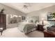 Spacious main bedroom featuring a ceiling fan, bright window, and beautiful decor at 2926 N 149Th Dr, Goodyear, AZ 85395