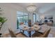 Bright dining area featuring a round table, four chairs, chandelier, and access to an outdoor space through sliding glass doors at 3033 N 39Th St # 5, Phoenix, AZ 85018