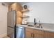 Modern kitchen features stainless steel appliances, stylish cabinets, quartz countertops, and floating shelves with lighting at 3033 N 39Th St # 5, Phoenix, AZ 85018