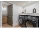 Convenient laundry room with washer, dryer, and adjacent powder room at 3033 N 39Th St # 5, Phoenix, AZ 85018