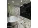 Luxurious bathroom with a soaking tub, frameless glass shower, and stunning black and white marble tile at 333 W Bethany Home Rd, Phoenix, AZ 85013