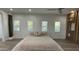 Bright bedroom featuring three windows, luxury vinyl floors and a modern ceiling fan at 333 W Bethany Home Rd, Phoenix, AZ 85013