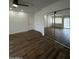 Bright bedroom with hardwood floors, closet with mirrors, and access to the exterior at 333 W Bethany Home Rd, Phoenix, AZ 85013