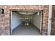 Modern garage featuring epoxy flooring, overhead lighting, stone accents, and garage door opener at 333 W Bethany Home Rd, Phoenix, AZ 85013