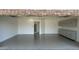 Clean garage interior with epoxy flooring, storage cabinets, and an entry door to the home at 333 W Bethany Home Rd, Phoenix, AZ 85013
