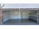 Spacious garage featuring epoxy flooring, built-in cabinets, and stone accents around the garage door at 333 W Bethany Home Rd, Phoenix, AZ 85013