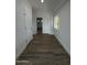 Bright hallway with hardwood floors, white walls, trim and doors, plus an arched doorway and natural light at 333 W Bethany Home Rd, Phoenix, AZ 85013