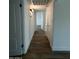 Hallway with hardwood floors, neutral paint, and interior doors at 333 W Bethany Home Rd, Phoenix, AZ 85013