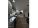 Bright kitchen with granite countertops, stainless steel sink, and white cabinets at 333 W Bethany Home Rd, Phoenix, AZ 85013
