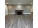 Open living room with hardwood floors, brick fireplace, and lots of light at 333 W Bethany Home Rd, Phoenix, AZ 85013