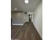 Open-concept living room with wood-style flooring leading to a bathroom at 333 W Bethany Home Rd, Phoenix, AZ 85013