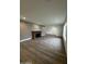 Large living room with hardwood floors, brick fireplace, and plenty of natural light at 333 W Bethany Home Rd, Phoenix, AZ 85013