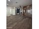 Open concept living space featuring hardwood floors, ceiling fan, unique partition wall, fireplace, and glass shower at 333 W Bethany Home Rd, Phoenix, AZ 85013