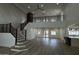 Bright living room with a staircase, balcony, wood floors, and a kitchen view at 333 W Bethany Home Rd, Phoenix, AZ 85013