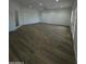 Large, bright living room with plenty of natural light and wood-style floors at 333 W Bethany Home Rd, Phoenix, AZ 85013