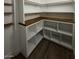 Organized pantry with white shelving, butcher block counters and hardwood floor at 333 W Bethany Home Rd, Phoenix, AZ 85013