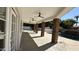 Covered patio with stone columns, ceiling fans, and a view of the sparkling pool and backyard at 333 W Bethany Home Rd, Phoenix, AZ 85013