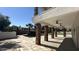 Covered patio with stone pillars offering shade and style, overlooking a refreshing pool and serene backyard at 333 W Bethany Home Rd, Phoenix, AZ 85013