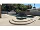 Inviting pool and spa area with lush landscaping, creating a private and serene backyard oasis at 333 W Bethany Home Rd, Phoenix, AZ 85013