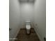 Small powder room features hardwood floors, white walls and trim, and a sleek, modern toilet at 333 W Bethany Home Rd, Phoenix, AZ 85013