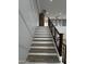 Staircase features wood treads with white risers and dark wood railings and banisters at 333 W Bethany Home Rd, Phoenix, AZ 85013